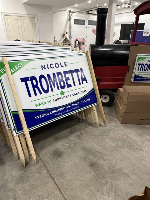 A stack of Nicole Trombetta lawn signs ready to go out