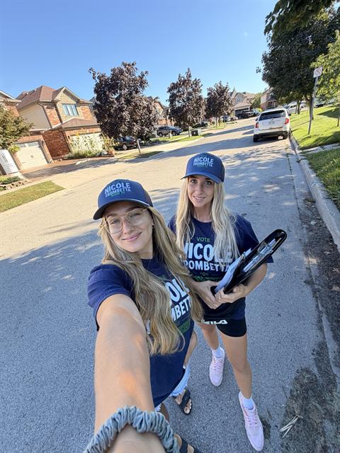 Nicole and a volunteer canvassing a neighbourhood street