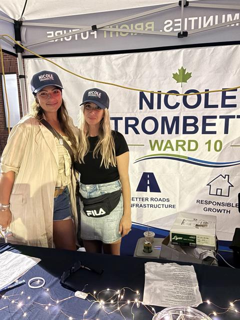 Nicole and a volunteer at the campaign booth