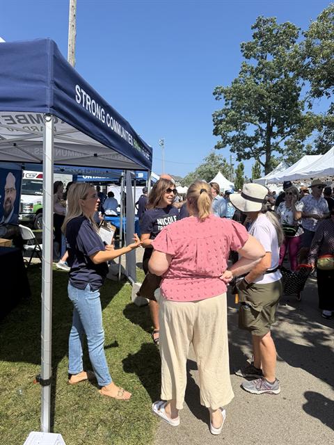 Nicole talking with residents at an outdoor event
