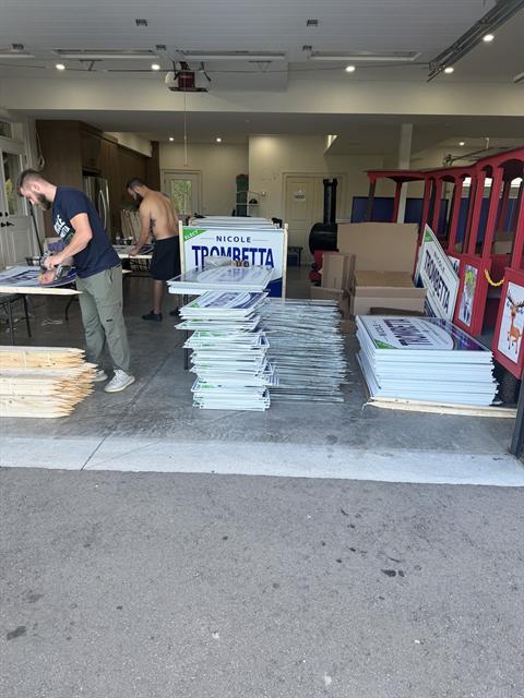 Volunteers preparing lawn signs