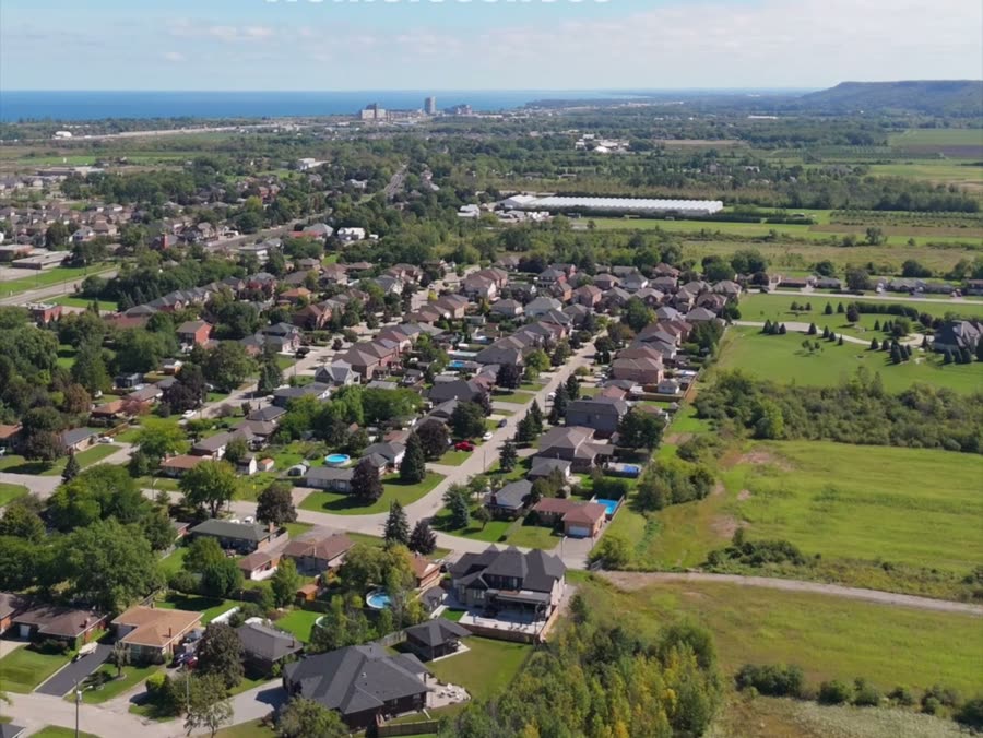 Aerial view of Ward 10 neighbourhoods and farmland stretching toward the Niagara Escarpment